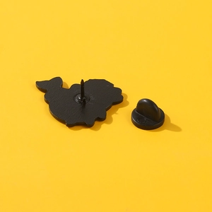 Marine animal enamel badge back view with black rubber pin clutch on yellow background