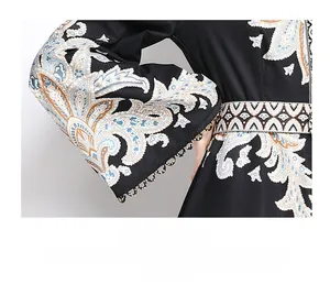 Détail des manches cloche avec imprimé paisley et bordure en dentelle festonnée