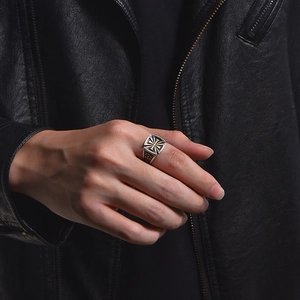 Vintage cross design ring for men with silver and black finish on a leather background