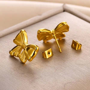 Macro view of 18K gold plated stainless steel bow earrings with a polished mirror finish