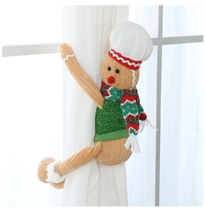 Detail of gingerbread man curtain tieback showing knitted texture and festive scarf