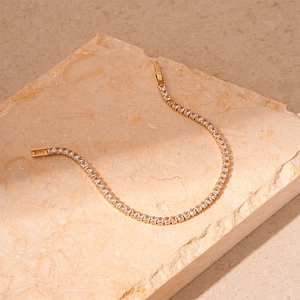 Close-up of gold geometric tennis bracelet with baguette-cut cubic zirconia crystals