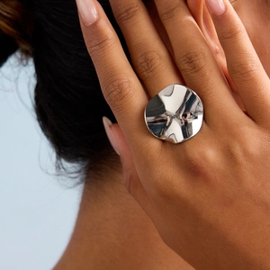 Minimalist silver wavy irregular stainless steel ring with mirror finish on hand