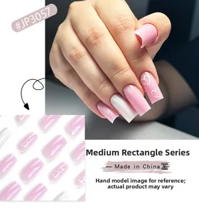 Detail of pink and white medium square press-on nails with sweet heart patterns