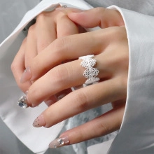 Detail of a double-layered star ring with zircon accents worn on a woman's hand