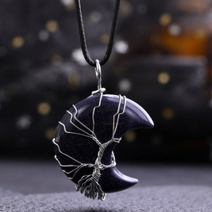 Close-up of Blue Sandstone moon pendant with silver Tree of Life wire wrap detail