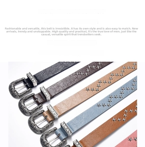 Detail of vintage PU leather belts with western buckles and star-shaped metal rivets