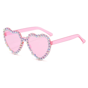 Detail view of pink heart-shaped sunglasses with vibrant rainbow rhinestones on the frame