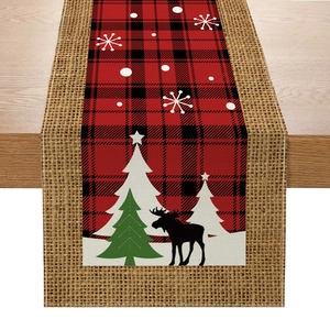 Christmas table runner with red buffalo plaid, reindeer and tree prints on linen wood table