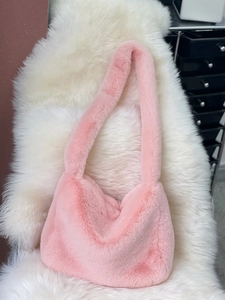 Detail of pink faux rabbit fur shoulder bag showing soft plush texture and Y2K aesthetic