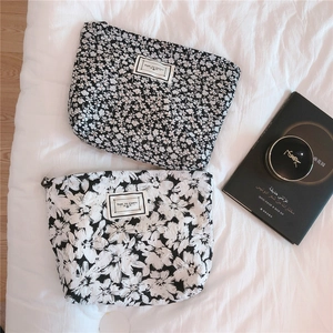 Detailed close-up of monochrome floral seersucker pouches with time to party labels