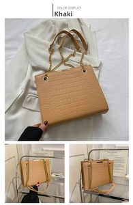 Close-up of khaki tote bag featuring crocodile embossing and gold chain strap detail