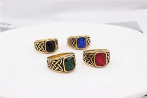 Detail of Viking Celtic totem rings with colorful gemstones and textured metal bands