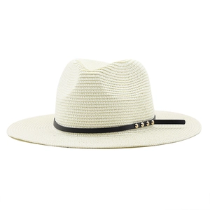 Minimalist beige straw panama hat with black leather band and gold rivets detail