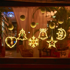 Close-up of LED Christmas suction cup lights showing six festive shapes on a window glass