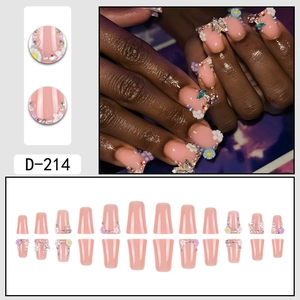 Press-on nails featuring 3D floral designs, metal butterflies, and pearls on nude pink base