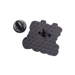Macro detail of enamel pin back with black matte honeycomb texture and rubber clutch