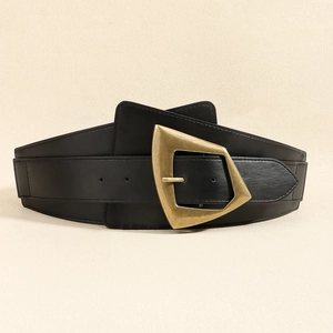 Detail of a wide black elastic waist belt with a vintage gold geometric buckle