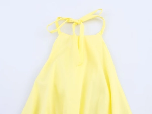 Detailed view of yellow halter neck top showing secure back tie and lightweight fabric