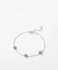 Detail of S925 sterling silver evil eye bracelet with blue zircons and heart tag