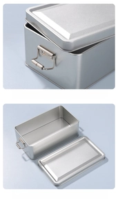 Close-up of silver tin box featuring secure roller buckle and rounded edge detail