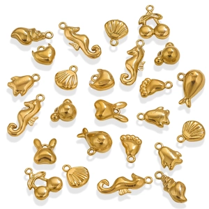 Detail of assorted gold stainless steel charms featuring seahorse, shell, and whale shapes
