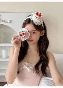 Detailed view of cute cherry cake headband and hair clip with lace trim on a model