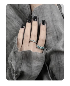 Detailed shot of textured S925 silver rings with green enamel on a model hand
