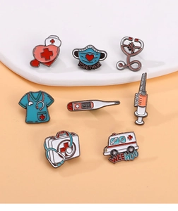 Set of eight medical-themed enamel pins featuring a stethoscope and ambulance on ceramic