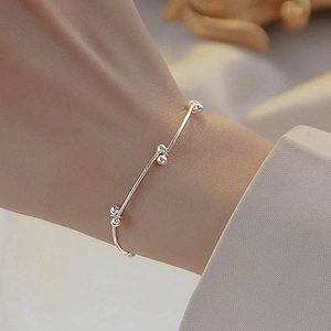 Minimalist silver beaded knot bracelet for women with elegant thin chain and polished beads
