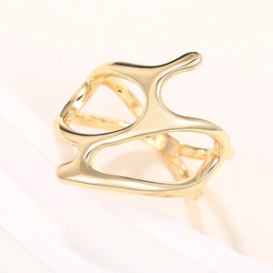 Detailed macro view of the gold irregular liquid metal ring with polished finish