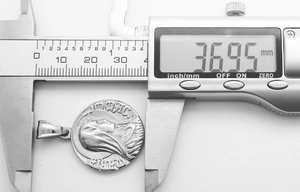 Digital caliper measuring the 37mm diameter of the vintage Greek mythology medallion pendant