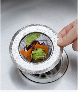 Close-up of stainless steel kitchen sink strainer filtering food waste effectively
