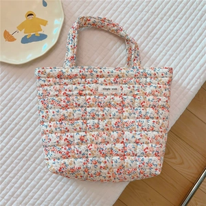 Quilted floral tote bag with red and blue flower patterns and a Simple Wish label