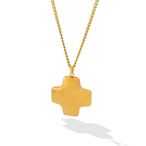 Detail of minimalist gold plated cross pendant with rounded edges and matte finish