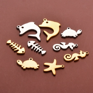 Detailed view of sea life charms including dolphin and starfish shapes in gold and silver
