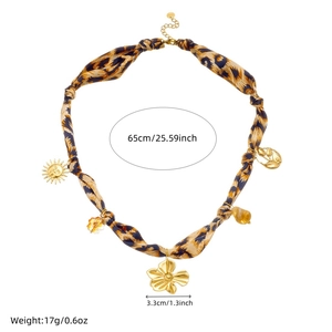 Detail shot of leopard print scarf necklace with sun and flower charms and measurements