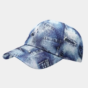 Detail of vintage denim print baseball cap with distressed texture and curved brim