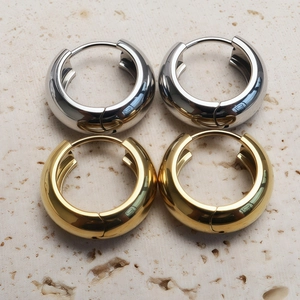 Polished 316L stainless steel hoop earrings in gold and silver set on stone