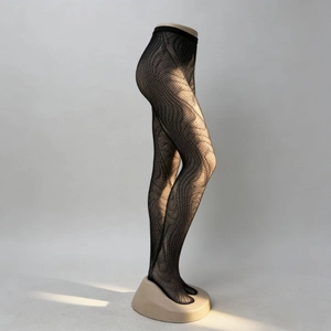 Detail of black wave pattern fishnet tights showing artistic textured weaving design