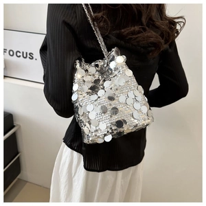 Detail of silver sequin bucket bag with large reflective scales and metal chain strap