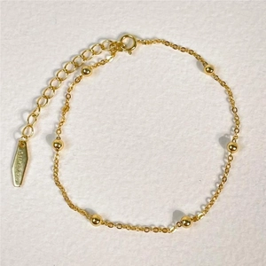 Close-up of S925 sterling silver gold beaded chain bracelet with adjustable extender
