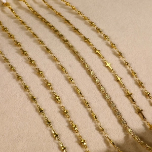 Selection of six gold stainless steel necklaces with heart star and cross pendants