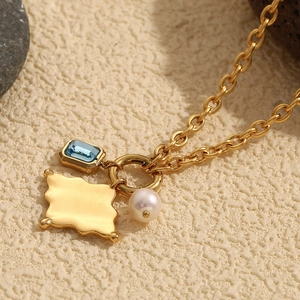 Gold 18K plated stainless steel necklace with blue gem, wave plate and pearl charms