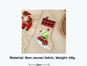 Detail of non-woven Christmas stocking with red truck design and tartan cuff