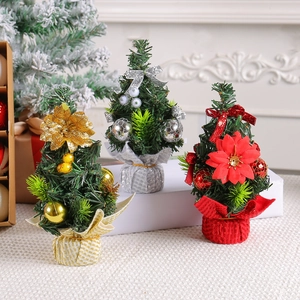 Mini tabletop Christmas trees decorated with festive colorful baubles and fabric bases