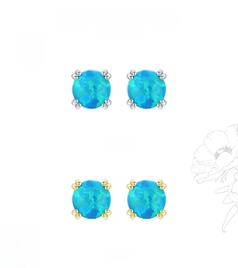Detail of silver and gold round opal stud earrings with vibrant blue-green fire