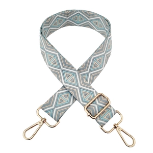 Detail of adjustable geometric diamond pattern bag strap with gold metal lobster clasps