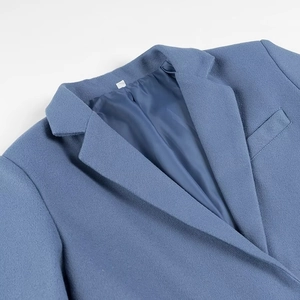 Detailed close-up of notch lapel and smooth dark blue inner lining on a wool jacket