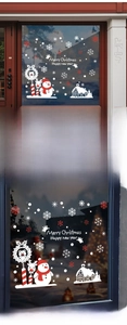 Dettaglio degli adesivi statici con fiocco di neve e pupazzo di neve su vetrina in vetro